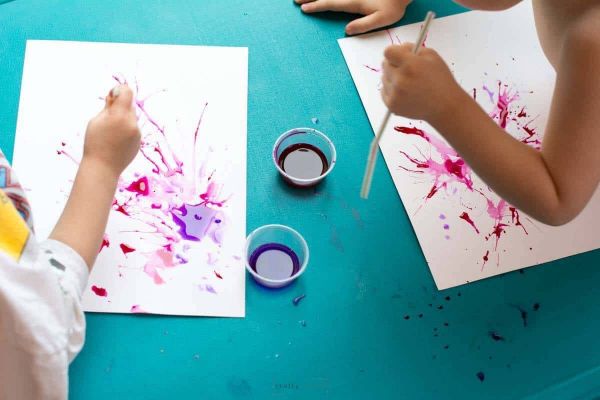 Drop liquid paint onto a sheet of paper
