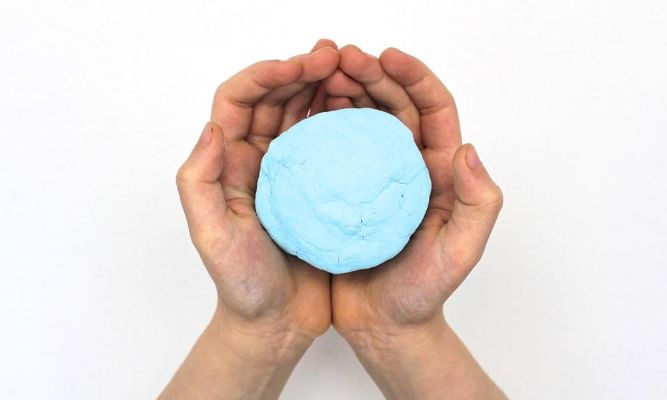 Flatten the playdough and press objects