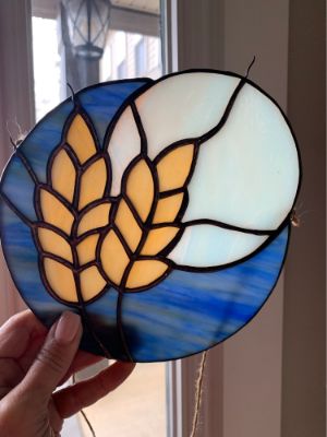 Glue colored grains onto translucent paper